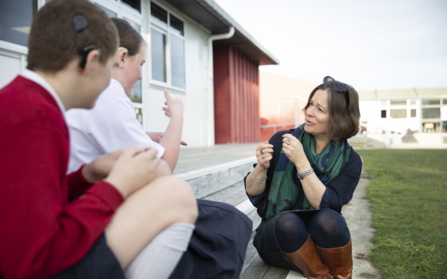 Teacher using sign language with kids - Ko Taku Reo